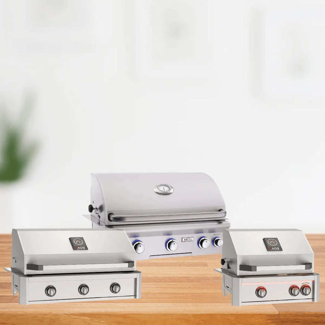AOG built-in grills collection with stainless steel gas grills featuring control knobs and temperature gauges, designed for modern outdoor kitchens.