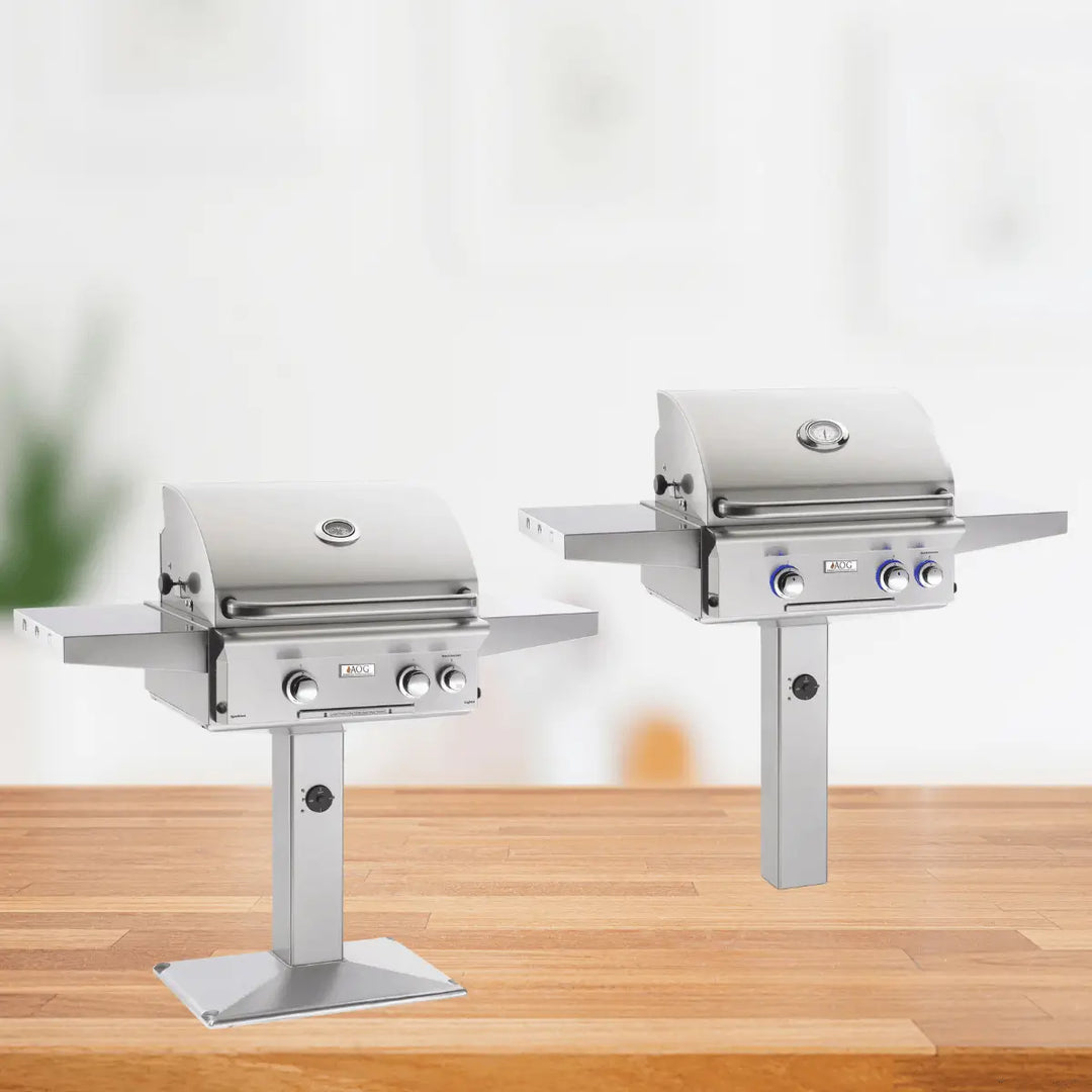 American Outdoor Grill L Series post mount grills with stainless steel finish, pedestal base, side shelves, and compact outdoor cooking design.