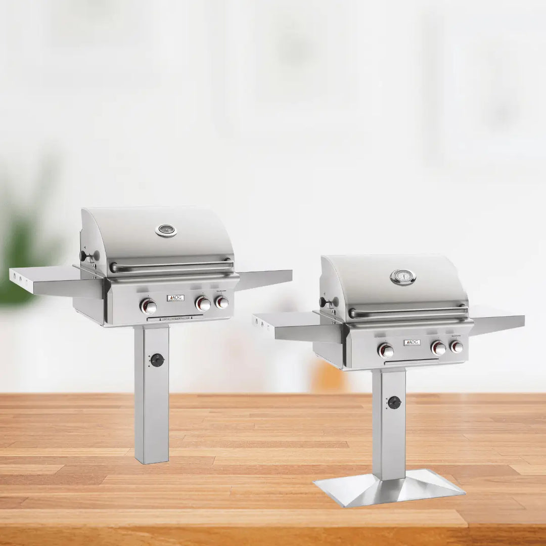 American Outdoor Grill T Series post mount grills with stainless steel design, pedestal base, side shelves, and outdoor cooking setup