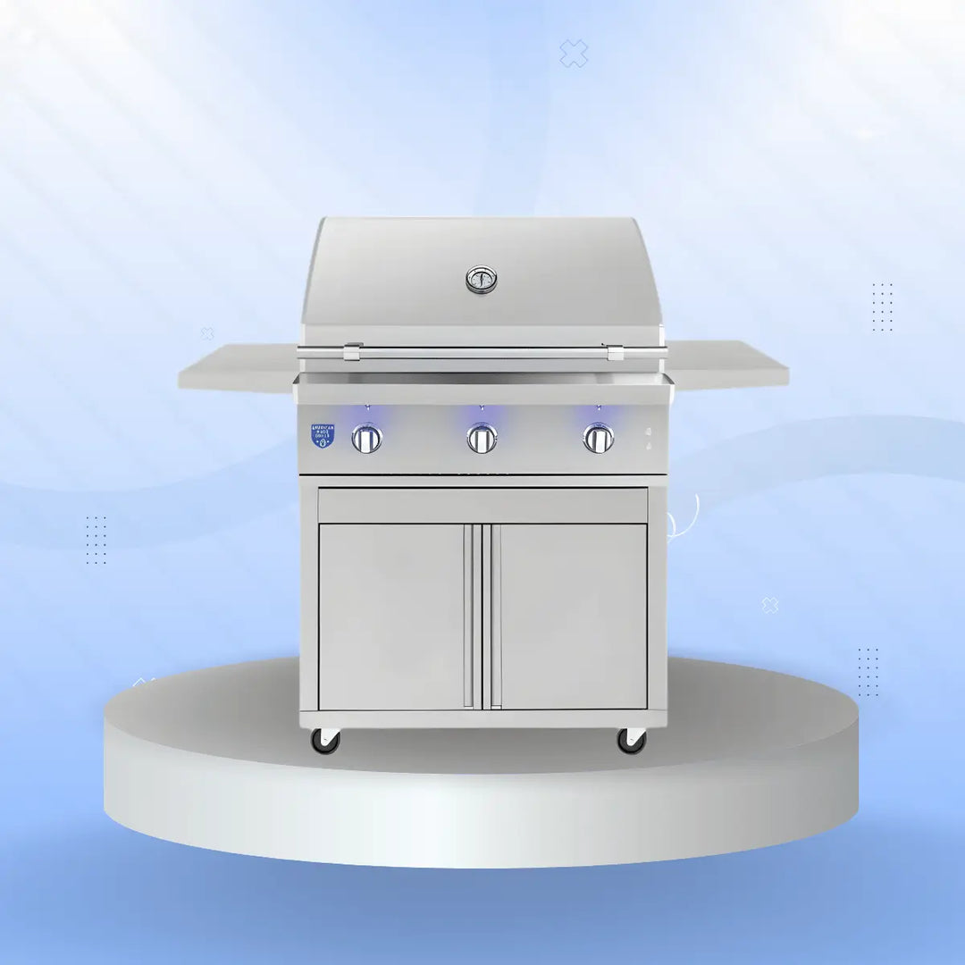 American Made Grills Atlas Series freestanding gas grill with stainless steel finish, three control knobs, side shelves, and double-door storage cabinet, displayed on a modern pedestal with a soft blue gradient background.