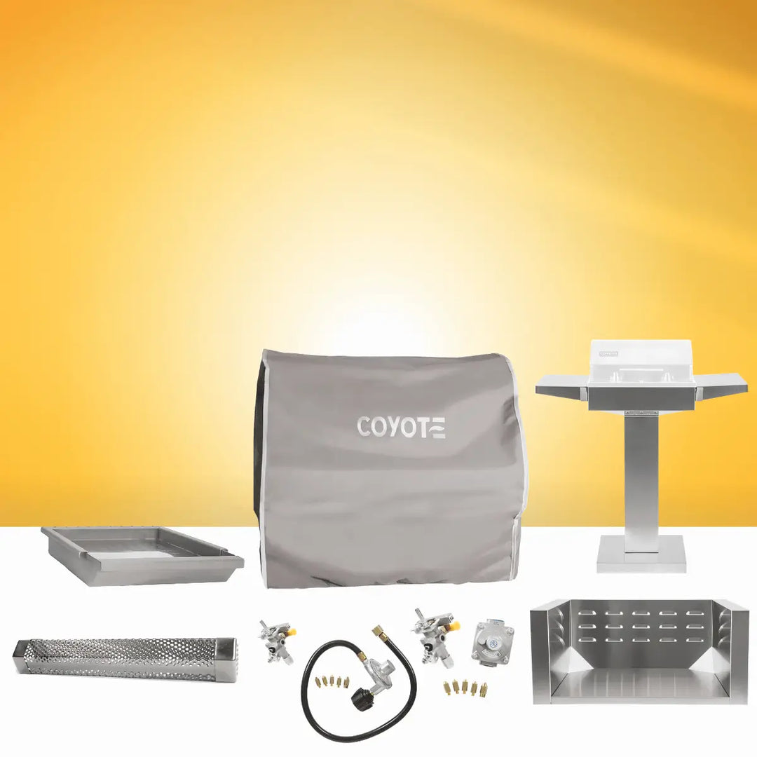 Coyote Outdoor Living grill accessories collection with cover, burner parts, smoker box, and gas regulator for outdoor grilling setups.