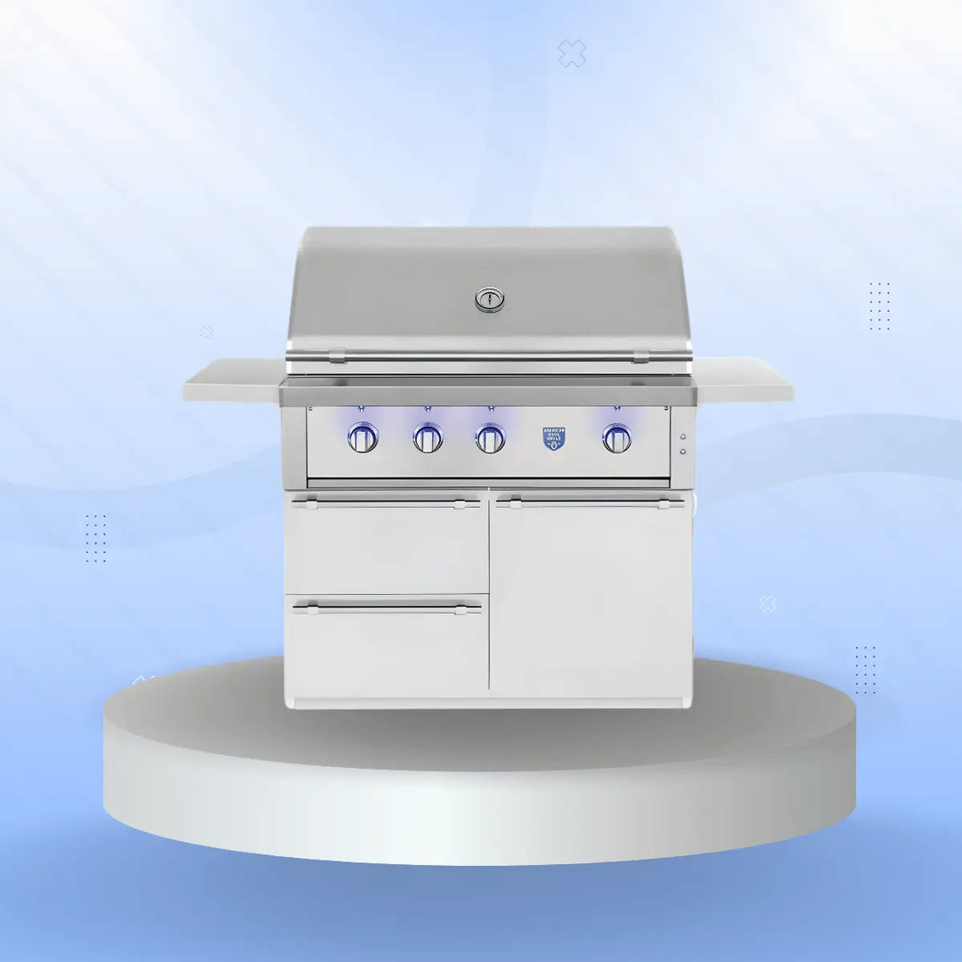 American Made Grills Estate Series freestanding gas grill with stainless steel construction, five illuminated control knobs, side shelves, and integrated storage drawers and cabinet, displayed on a modern pedestal with a soft blue gradient background.