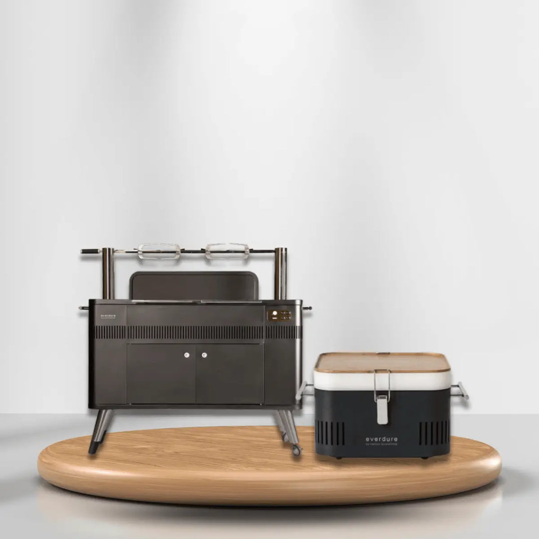 Everdure charcoal grills collection with full-size grill and portable charcoal unit on wooden platform for modern outdoor cooking