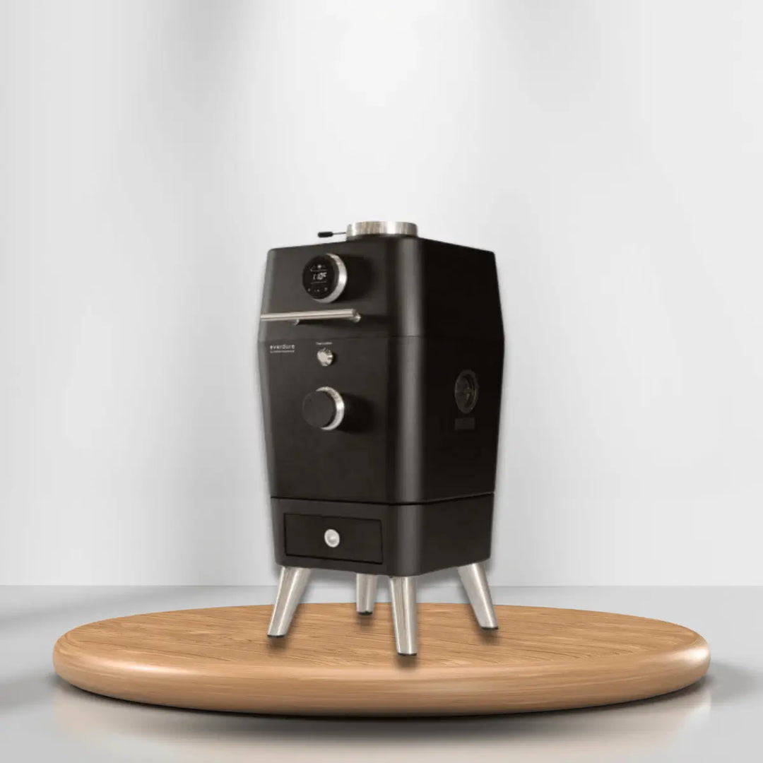 Everdure outdoor oven with temperature gauge and control knob, compact black design on wooden platform for modern outdoor cooking.