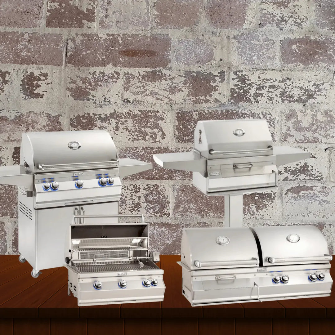 Fire Magic Aurora Series grills collection featuring premium stainless steel gas grills, including freestanding cart models, built-in units, pedestal grill, and double grill setup, displayed on a wooden surface with a rustic brick wall background.