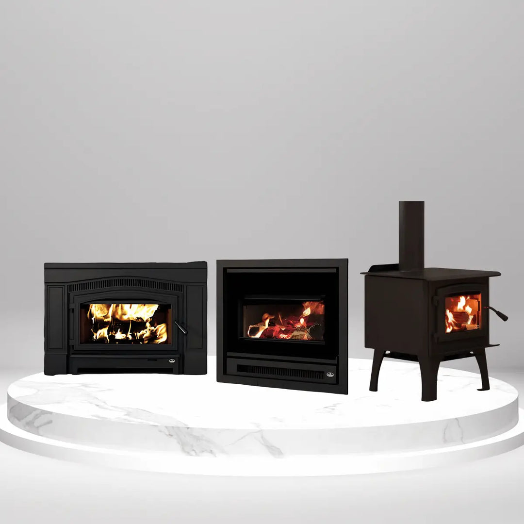 Osburn wood inserts and freestanding stove with visible flames, displayed on marble platform for home heating solutions collection.