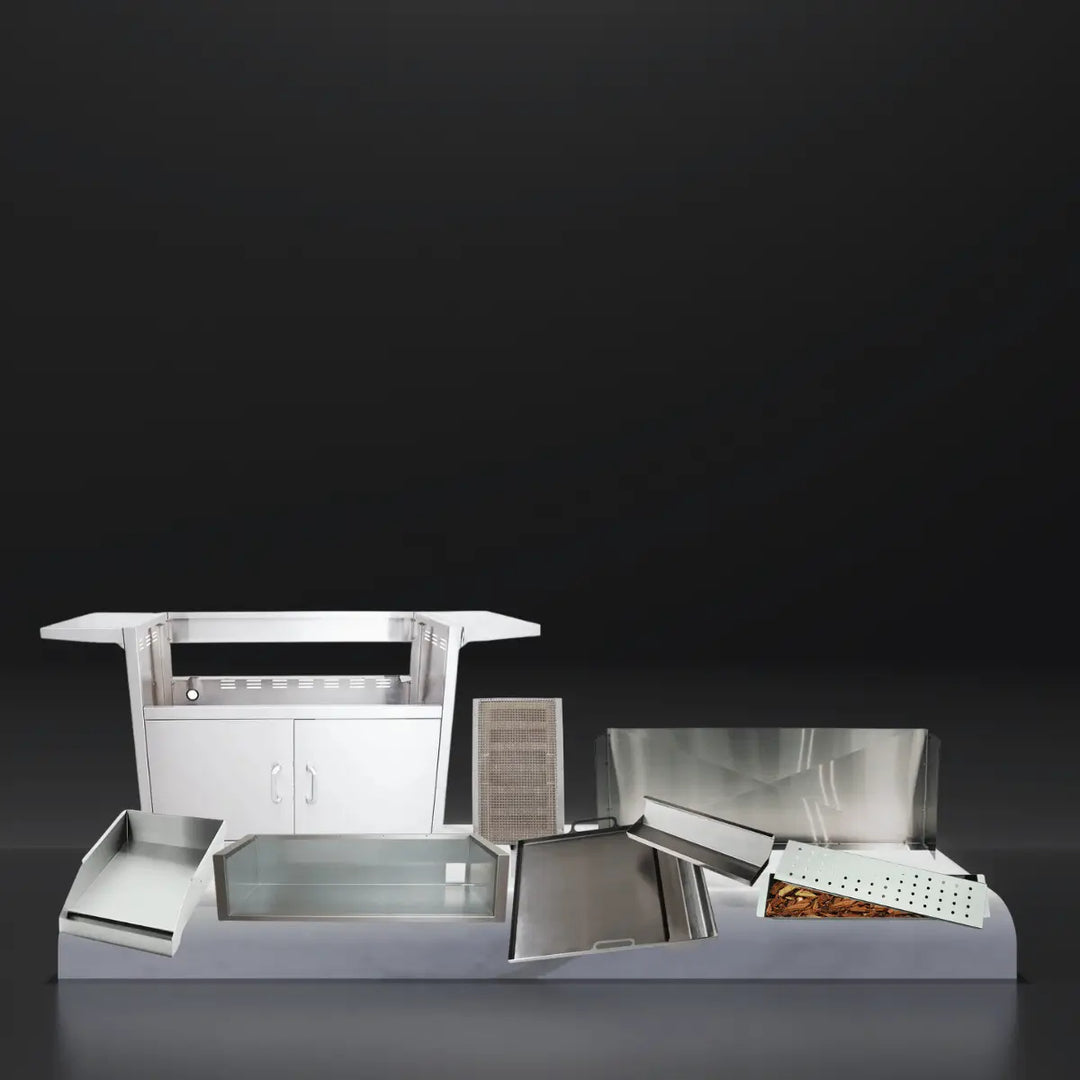 RCS grill accessories collection featuring stainless steel grill cart, trays, drip pans, heat shields, smoker box, and various insert components displayed on a platform against a dark background.