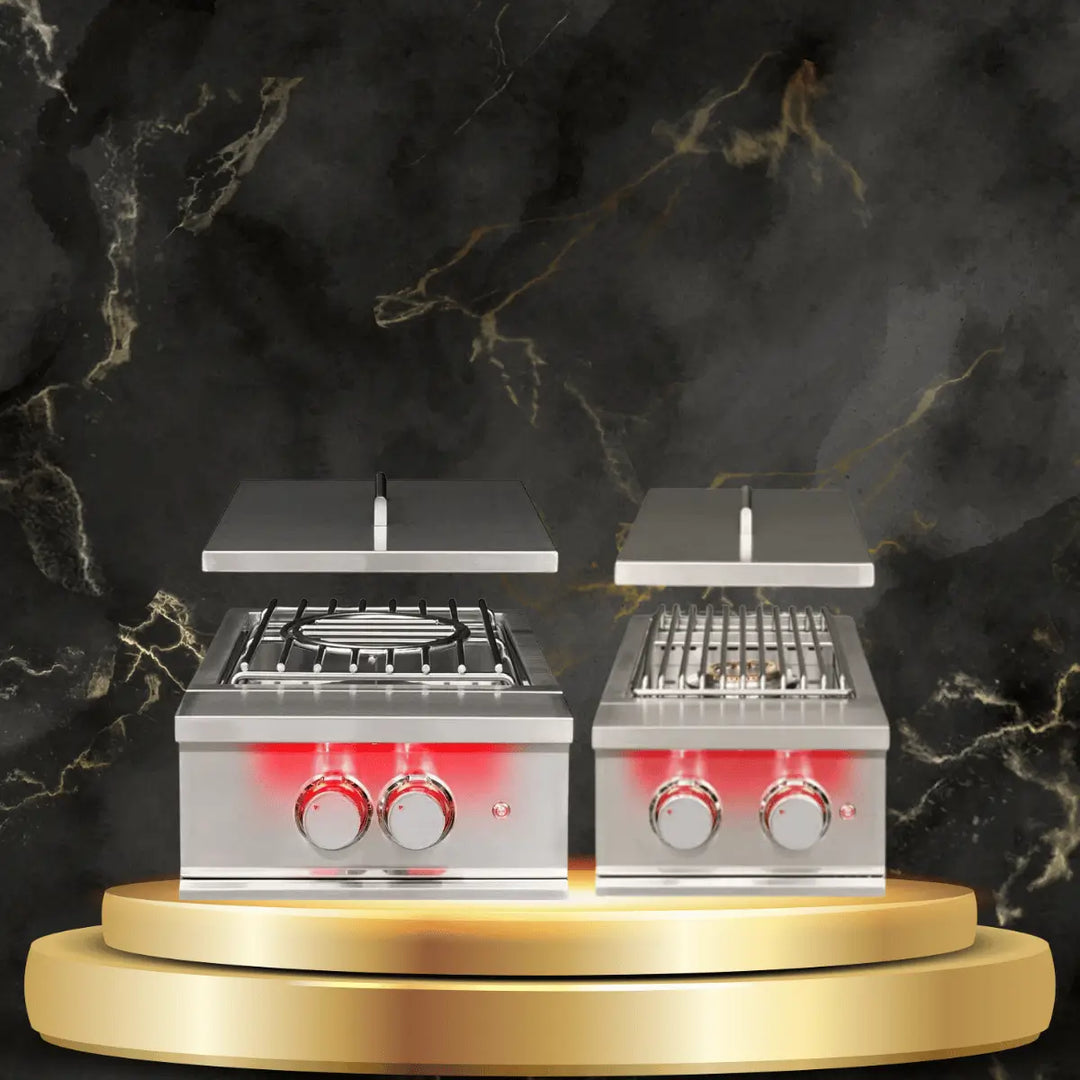 TrueFlame burners collection with stainless steel gas burners, open lids, and illuminated knobs on luxury outdoor display platform